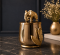Golden jar with elephant figurine